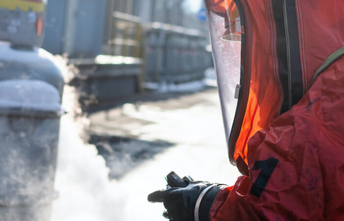Firefighters in protective chemical HAZMAT suits stop the leak of the dangerous substance ethylene oxide from the tank eto hazard suit