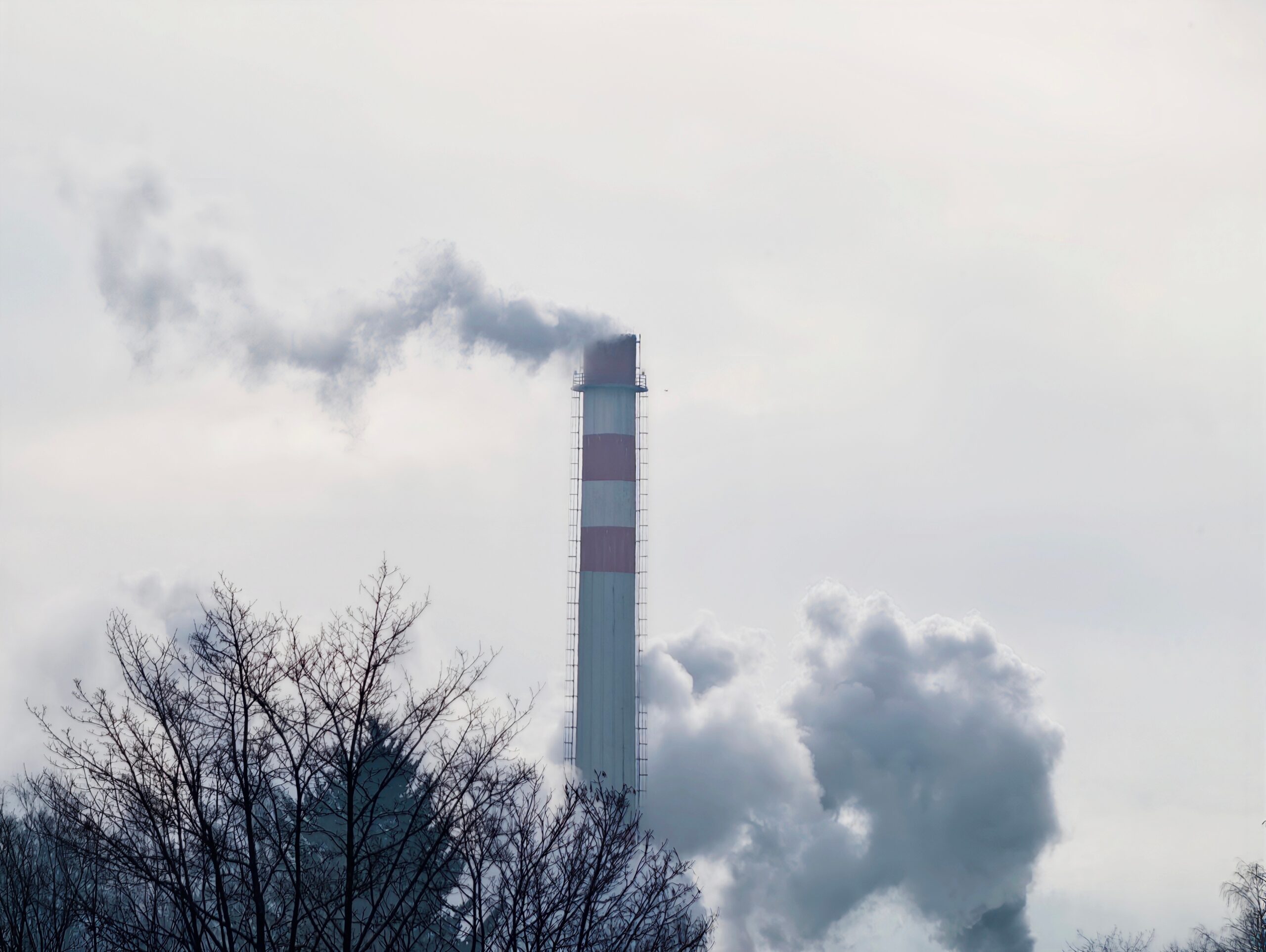 Pollution affecting surroundings. Hazy sky over trees and factories impacts community health safety Air Pollution